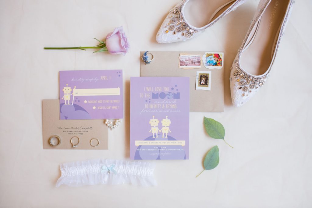 purple robot invitation suite paired with shoes and floral details