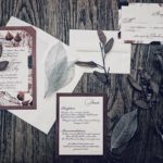 Burgundy weddin ginvitation wuite with organic leaf details by revelry + heart