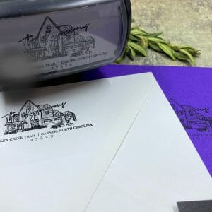 Reinking black stamp and imprint of address and artwork on white envelope